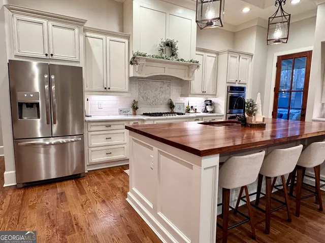 a bedroom with a bed and painting on the wall
