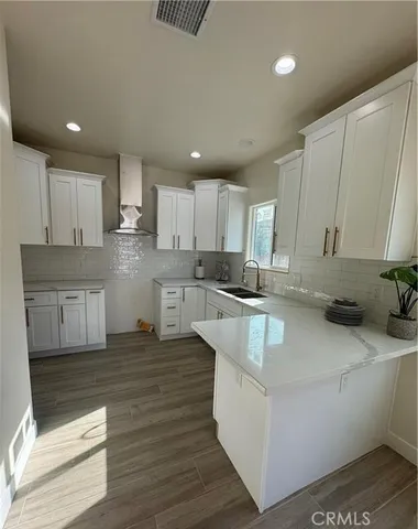 a large kitchen with stainless steel appliances granite countertop a stove a sink and a refrigerator