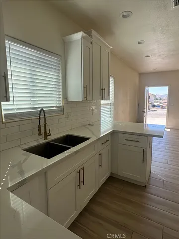 a kitchen with sink and cabinets