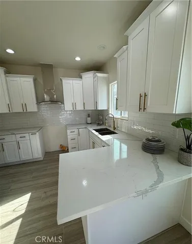 a kitchen with stainless steel appliances granite countertop a sink a stove and a refrigerator