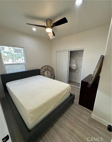 a bedroom with a bed and a large mirror