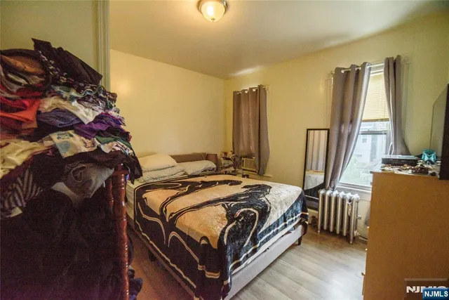 a bed sitting in a bedroom next to a window