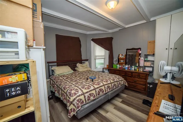 a bedroom with a bed and a tv