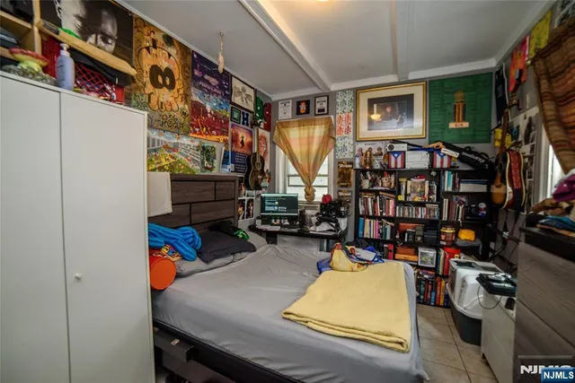 a room with lots of white furniture and a flat screen tv