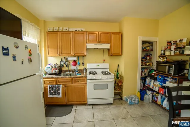 a kitchen with stainless steel appliances a stove and a refrigerator