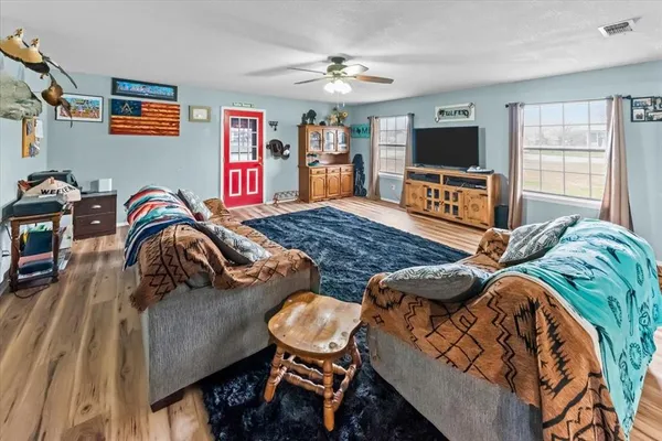 a bedroom with furniture and a flat screen tv