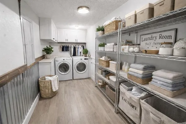 a bedroom with two beds and a chandelier