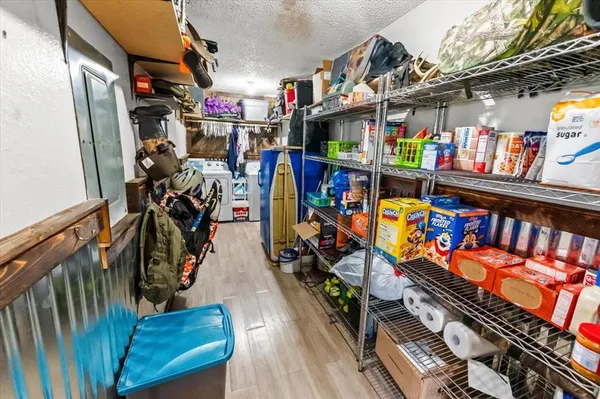 a bedroom with two beds and a painting on the wall