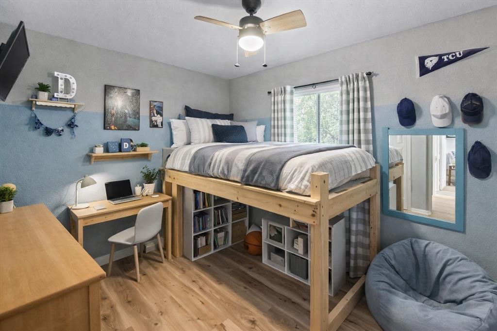600 South Colorado Street Whitney, TX 76692 - Photo 20 of 26 a bedroom with a bed and a chandelier