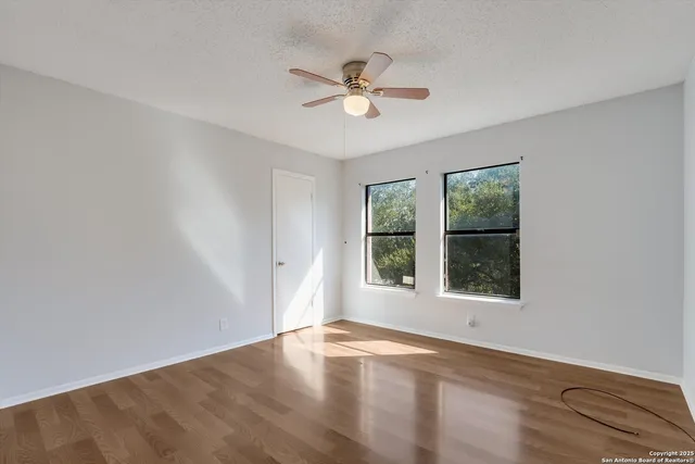 a view of an empty room with wooden floor