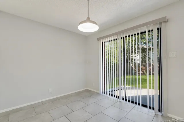 a kitchen with granite countertop a sink a stove top oven and cabinets