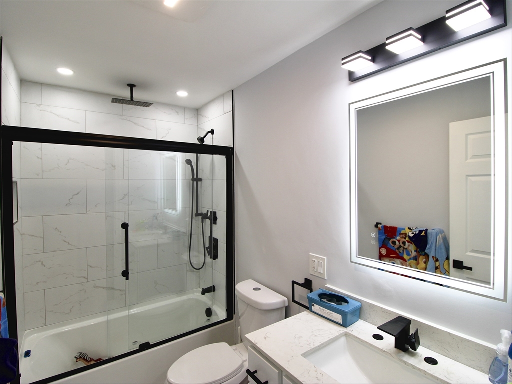 210 Nichols Street Gardner, MA 01440 - Photo 12 of 25 a bathroom with a bathtub shower sink vanity and toilet