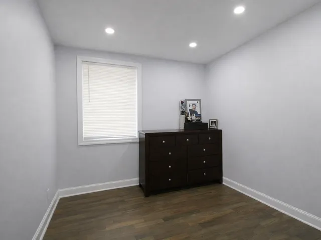 a room with a window and wooden floor