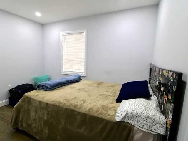 a bedroom with a bed and a walk in closet