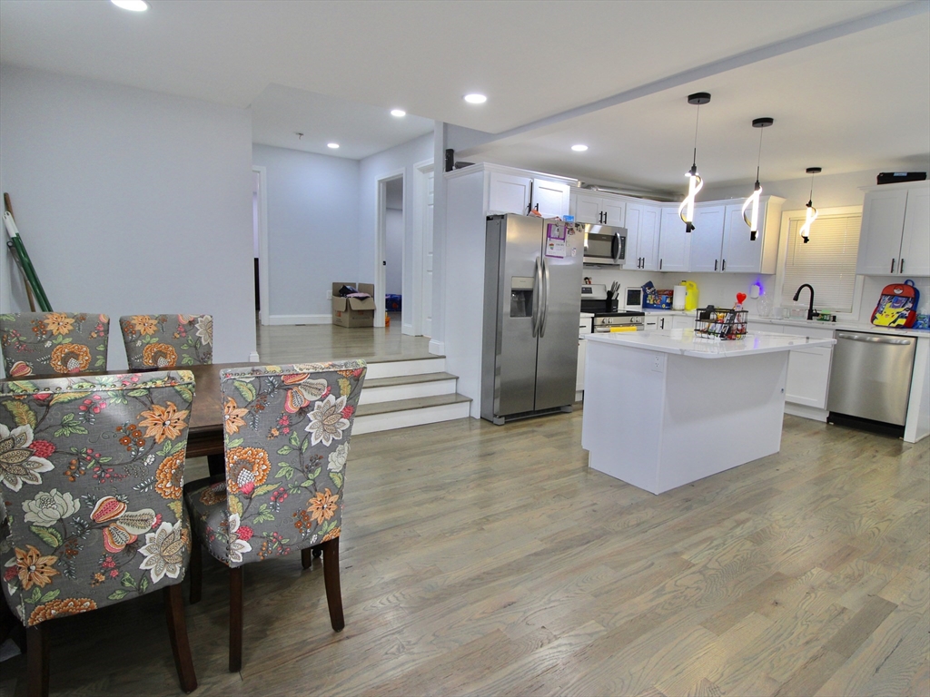 210 Nichols Street Gardner, MA 01440 - Photo 15 of 25 a living room with furniture and a dining table with wooden floor