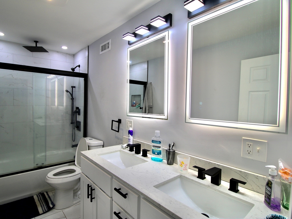 210 Nichols Street Gardner, MA 01440 - Photo 22 of 25 a bathroom with a sink toilet double vanity and shower