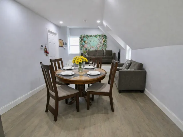 a kitchen with white cabinets stainless steel appliances and a window