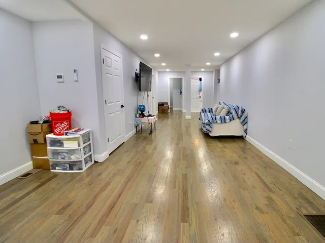 a large room with wooden floor and furniture