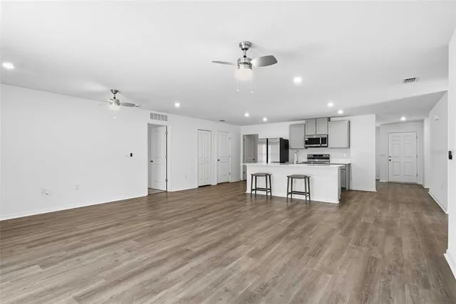 a view of a kitchen with a sink and a refrigerator