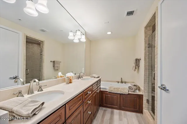 a bathroom with a sink double vanity granite and a mirror