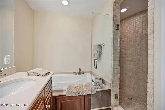 a bathroom with a granite countertop sink a shower and a mirror