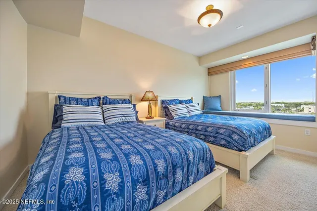 a bedroom with a large bed and a large window