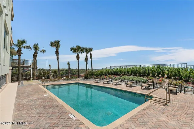a view of swimming pool with a table and chairs