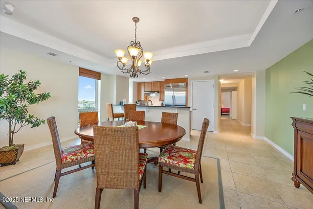 a view of a dining room with furniture wooden floor and chandelier