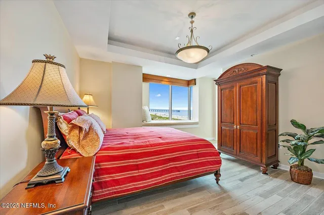 a bedroom with a bed and a chandelier