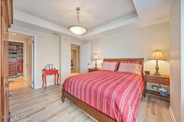 a bedroom with bed and a chandelier