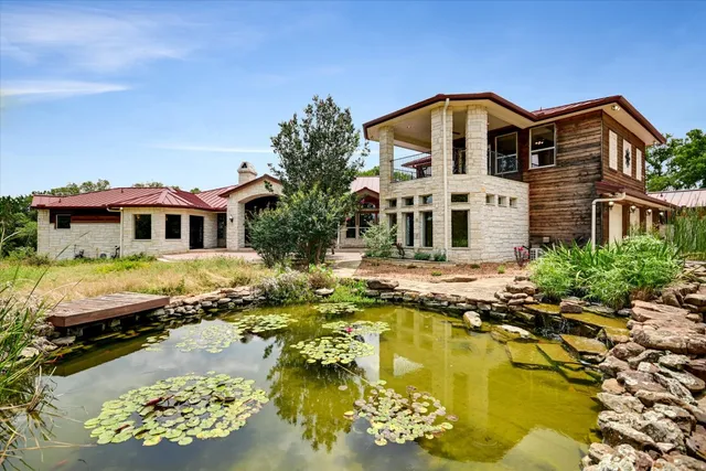 a view of a lake with boats and trees around
