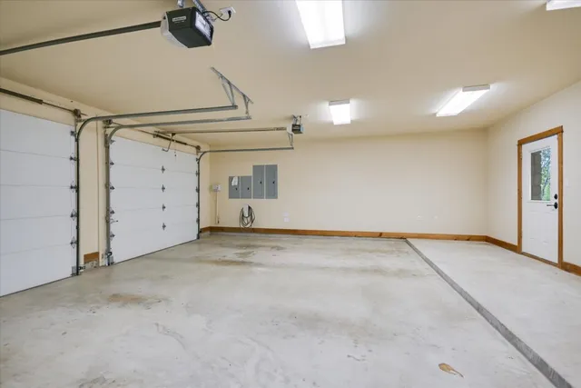 a large white kitchen with a large window
