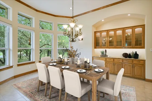 a view of a dining room with furniture large windows and wooden floor
