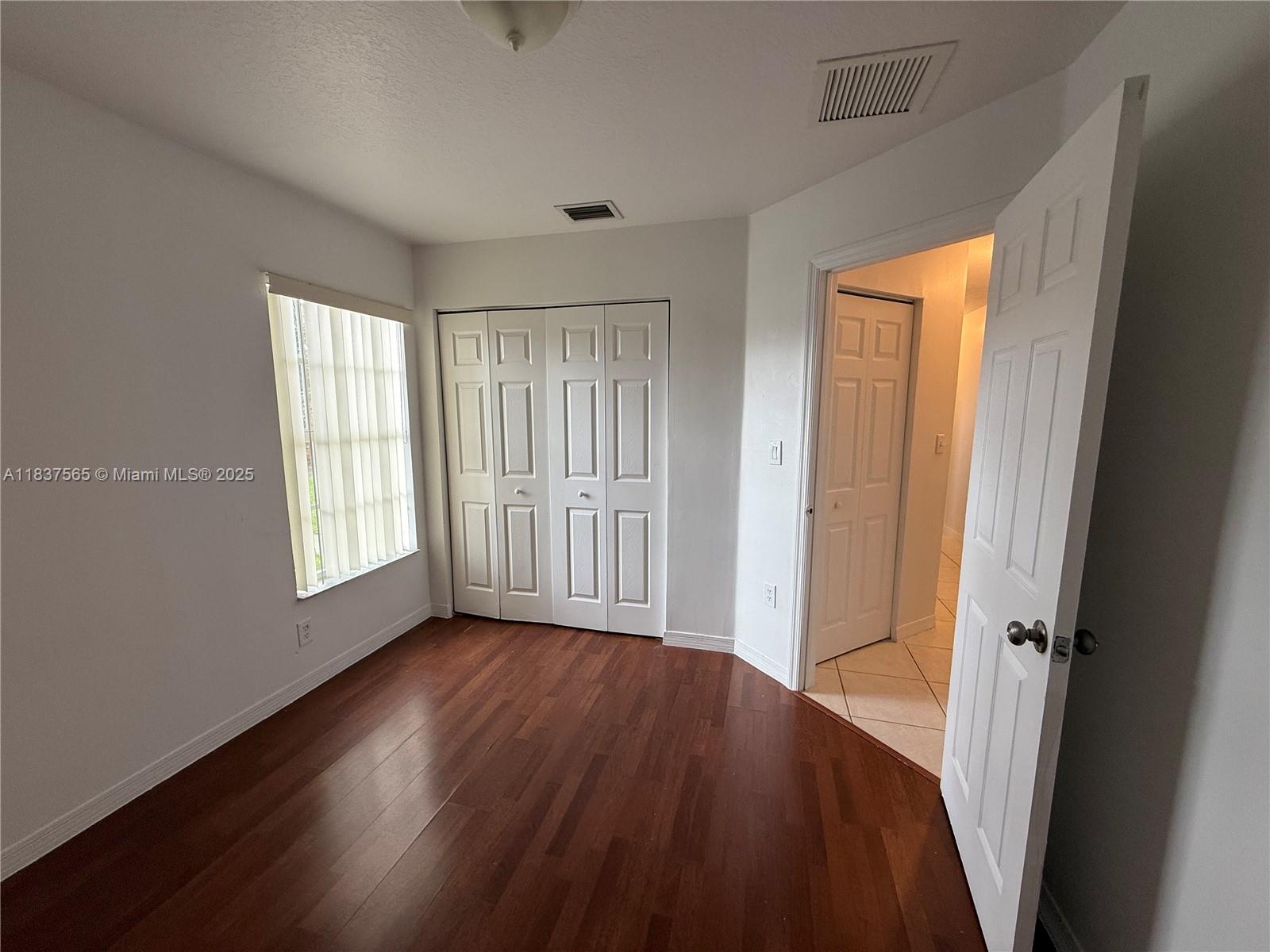 Naranja Homestead, FL 33032 - Photo 13 of 17 an empty room with wooden floor and windows