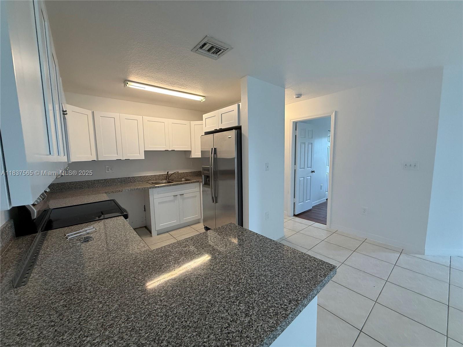 Naranja Homestead, FL 33032 - Photo 6 of 17 a kitchen with stainless steel appliances granite countertop a sink stove and refrigerator