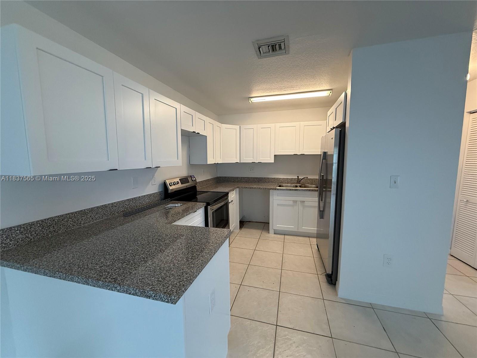 Naranja Homestead, FL 33032 - Photo 7 of 17 a kitchen with stainless steel appliances granite countertop a sink stove and cabinets
