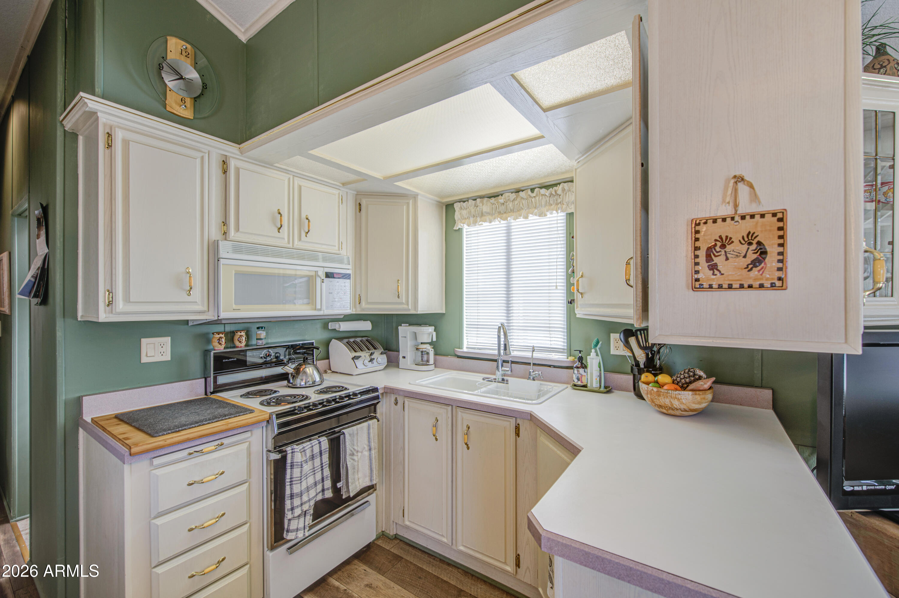 111 South Greenfield Road, Unit 408 Mesa, AZ 85206 - Photo 11 of 22 a kitchen with stainless steel appliances granite countertop a sink stove and cabinets