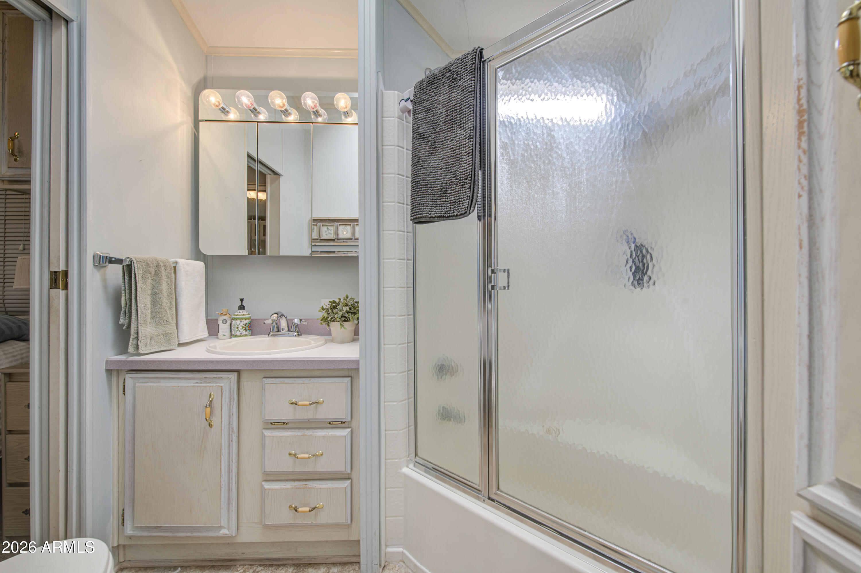 111 South Greenfield Road, Unit 408 Mesa, AZ 85206 - Photo 13 of 22 a bathroom with a shower a mirror and a sink