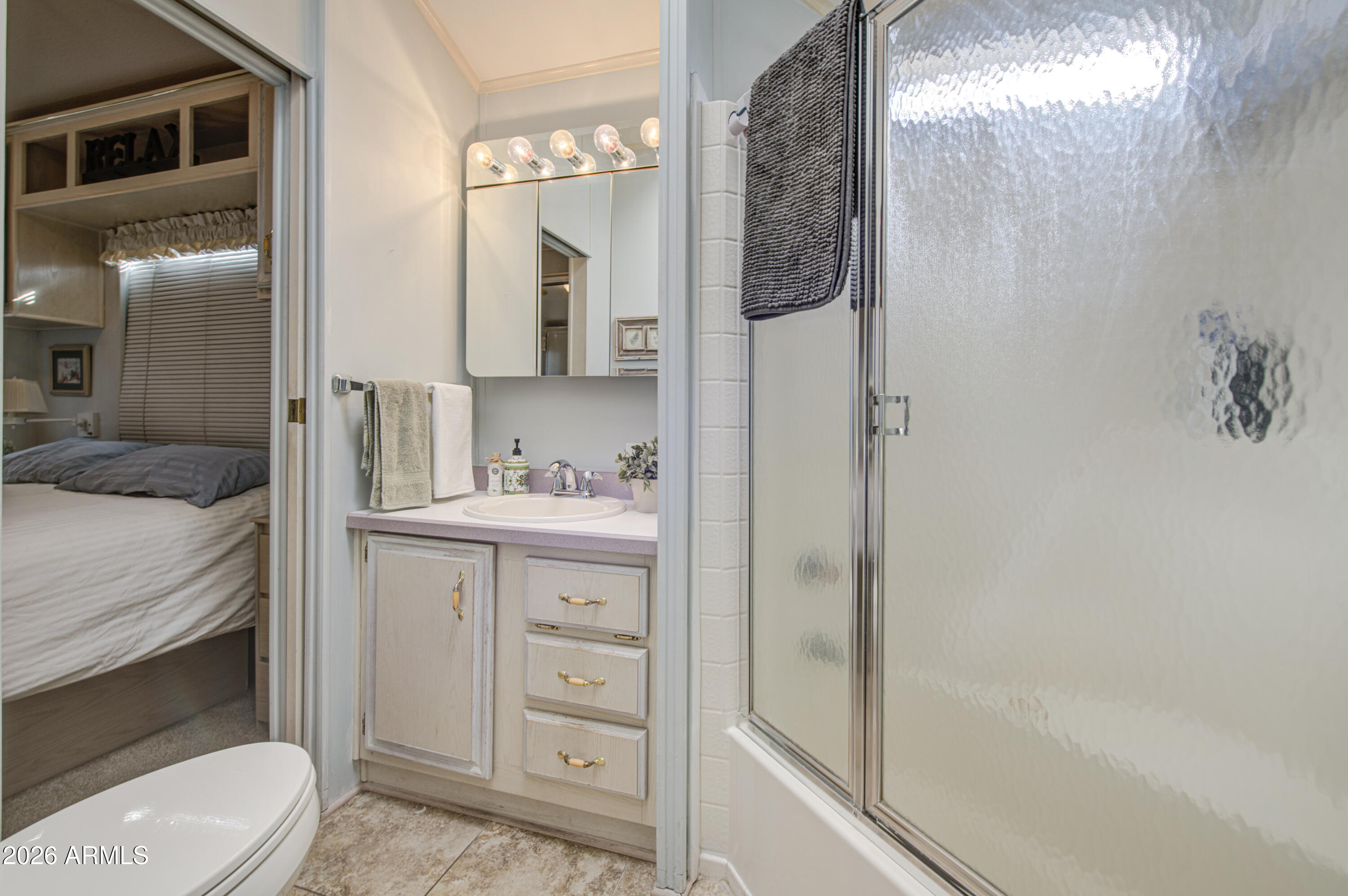 111 South Greenfield Road, Unit 408 Mesa, AZ 85206 - Photo 14 of 22 a en suite bathroom with a sink a toilet and shower