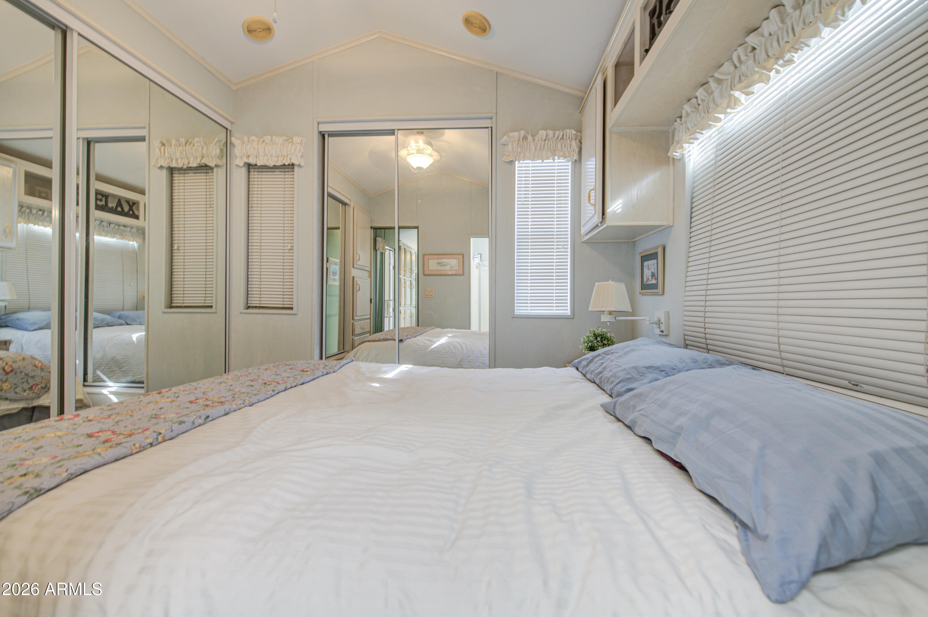 111 South Greenfield Road, Unit 408 Mesa, AZ 85206 - Photo 16 of 22 a large bedroom with a large bed and chandelier