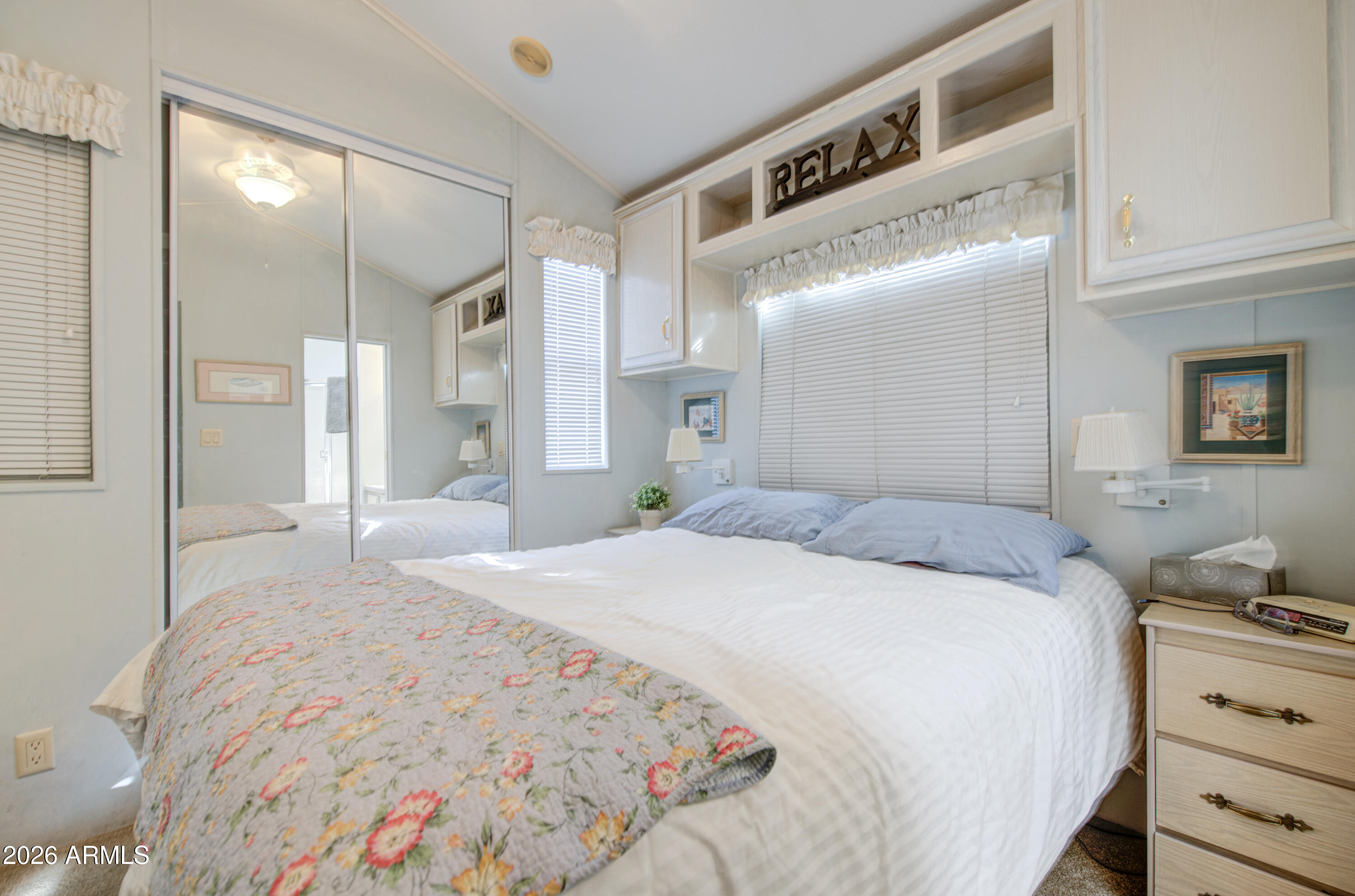 111 South Greenfield Road, Unit 408 Mesa, AZ 85206 - Photo 17 of 22 a spacious bedroom with a bed and a mirror