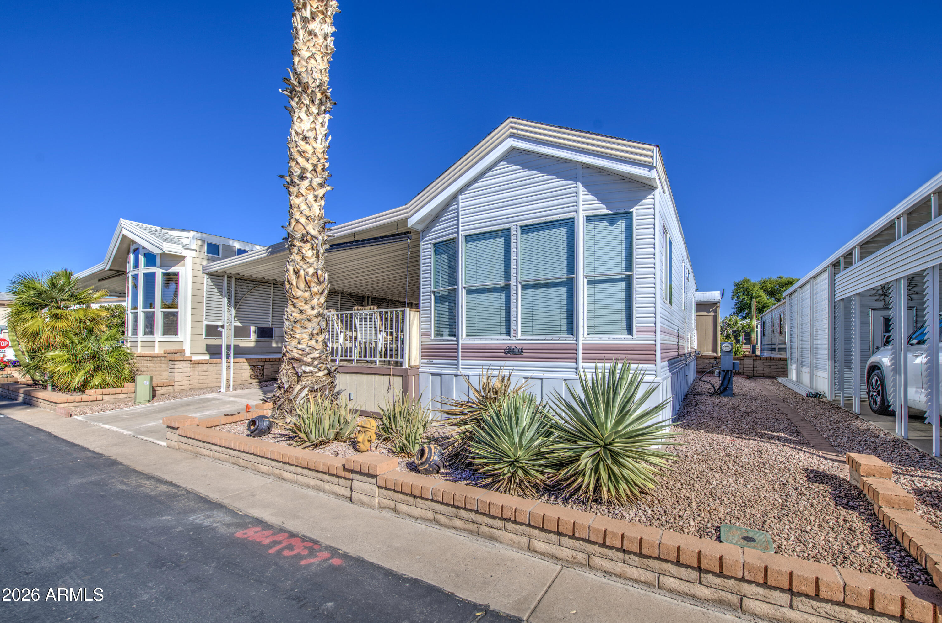 111 South Greenfield Road, Unit 408 Mesa, AZ 85206 - Photo 2 of 22 a front view of a house with garden