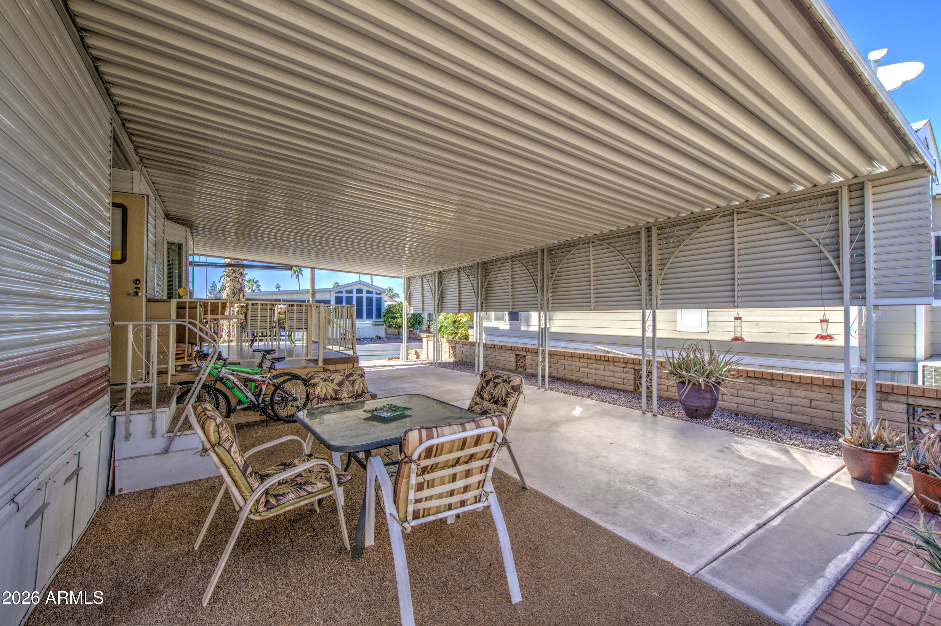 111 South Greenfield Road, Unit 408 Mesa, AZ 85206 - Photo 22 of 22 a view of a patio with table and chairs and potted plants