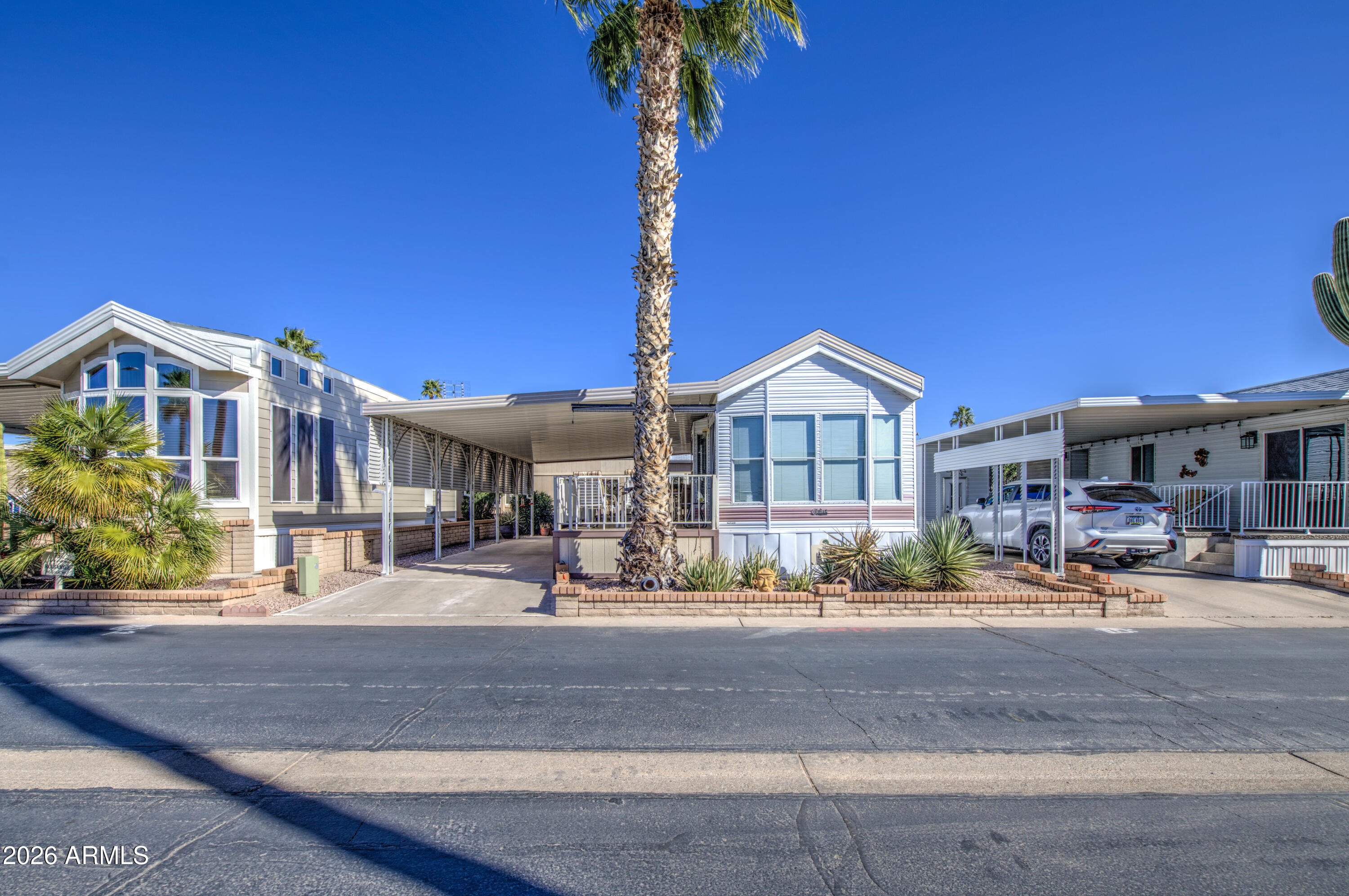 111 South Greenfield Road, Unit 408 Mesa, AZ 85206 - Photo 3 of 22 a front view of a house with garden and patio
