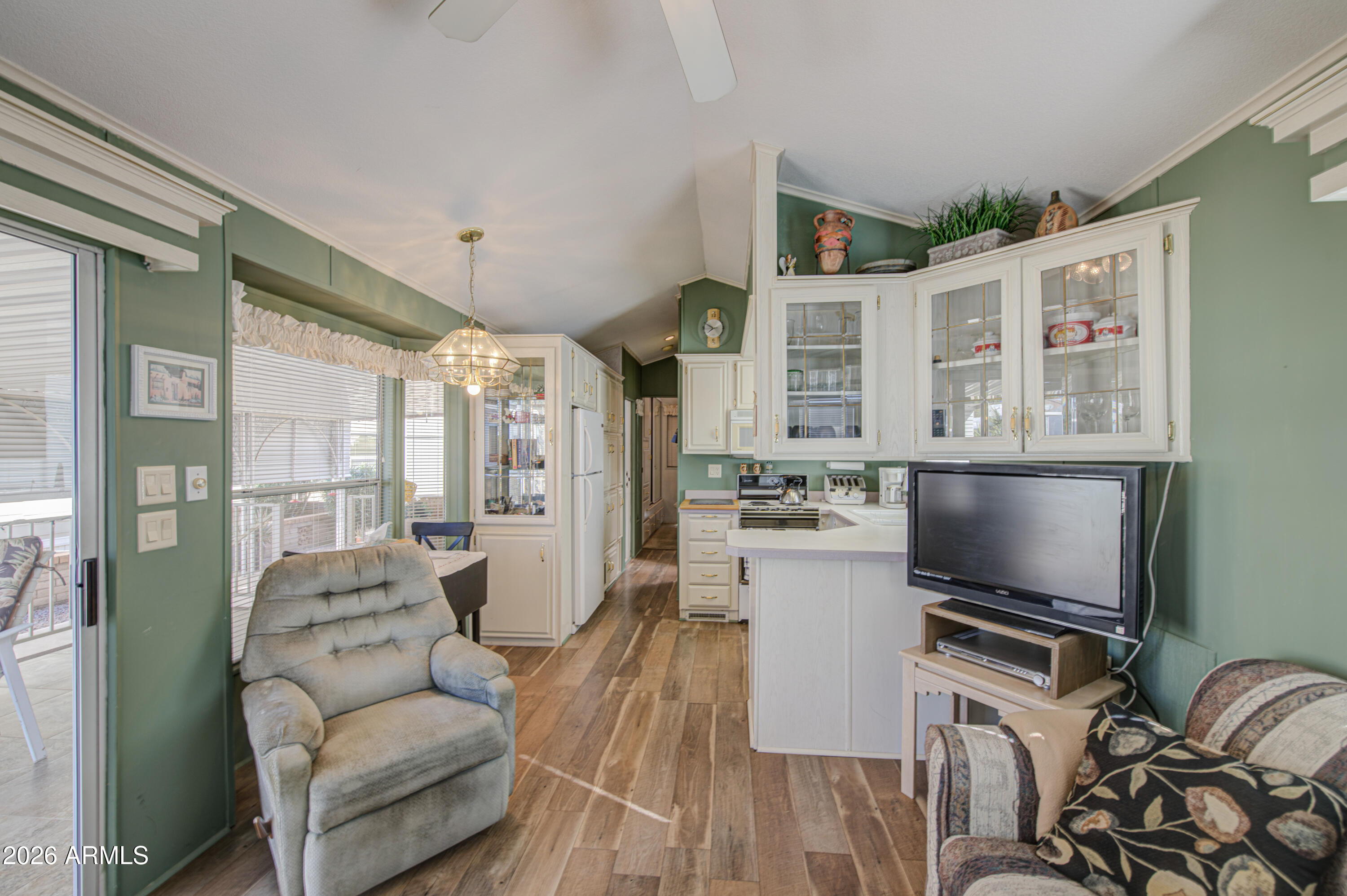 111 South Greenfield Road, Unit 408 Mesa, AZ 85206 - Photo 9 of 22 a living room with furniture and a flat screen tv