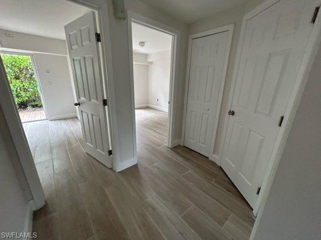 1555 Blue Point Avenue, Unit 3 Naples, FL 34102 - Photo 3 of 9 Hallway featuring light wood-type flooring