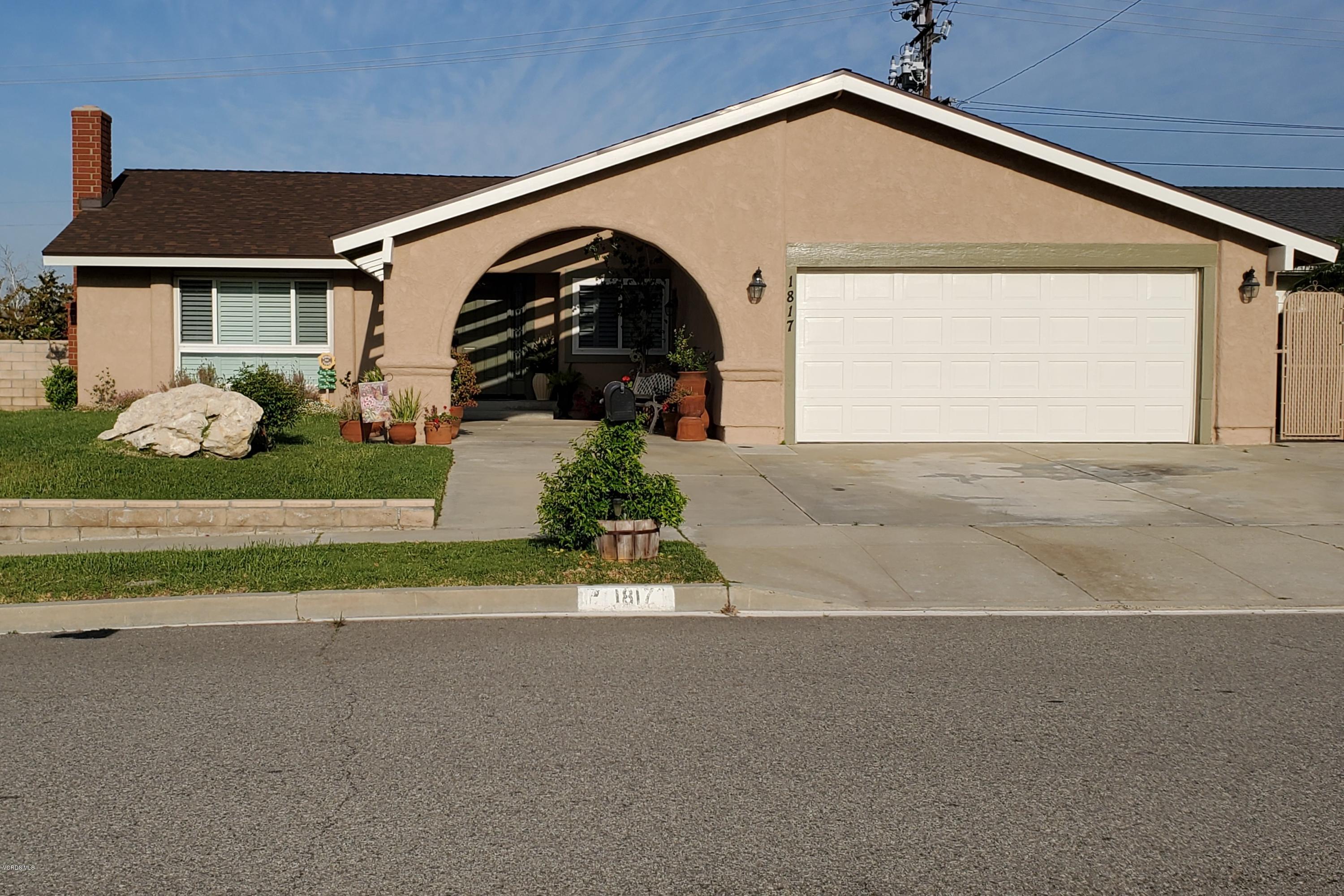 a front view of a house with a yard garage and outdoor seating