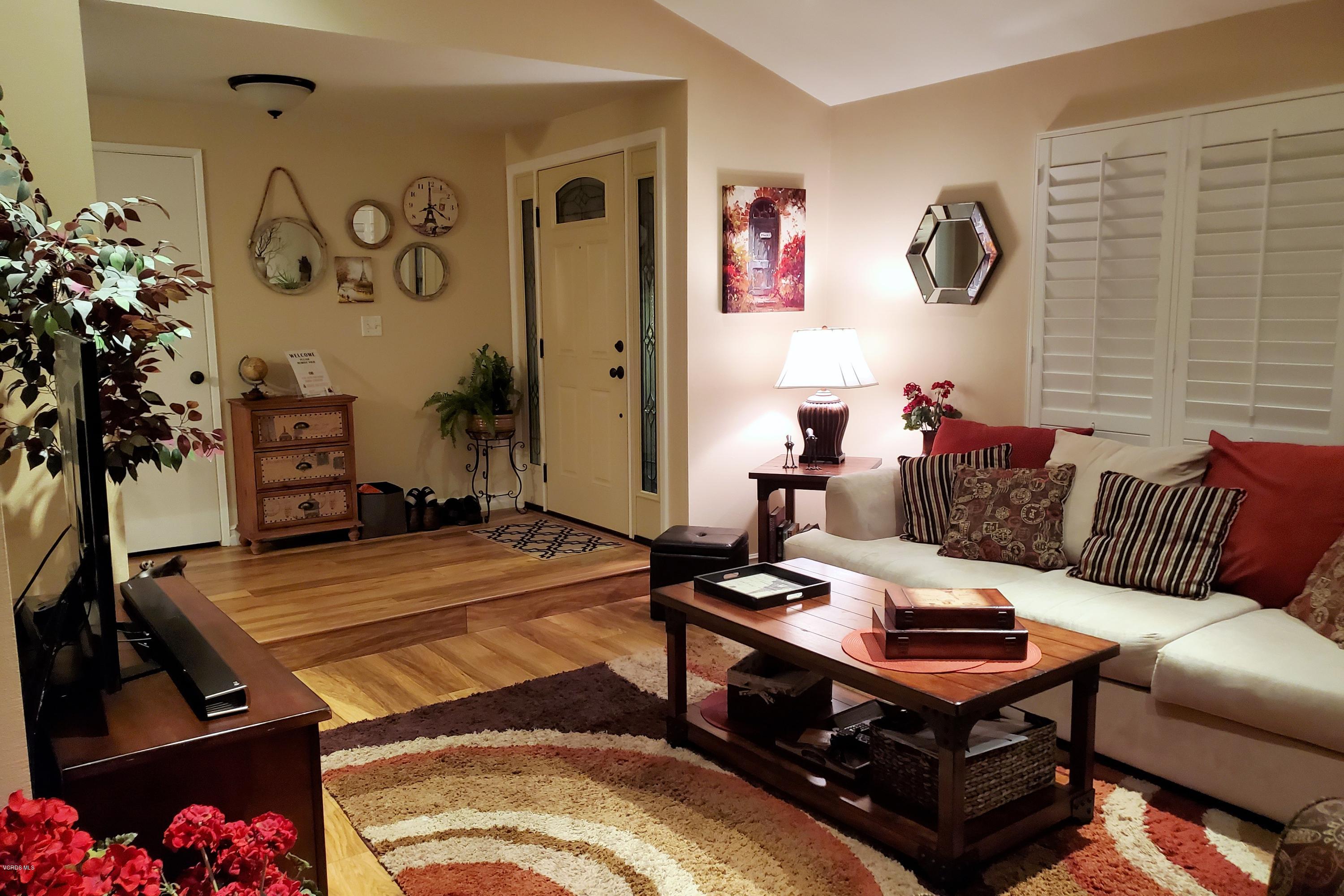 1817 Belhaven Avenue Simi Valley, CA 93063 - Photo 13 of 39 a living room with patio furniture and a potted plant