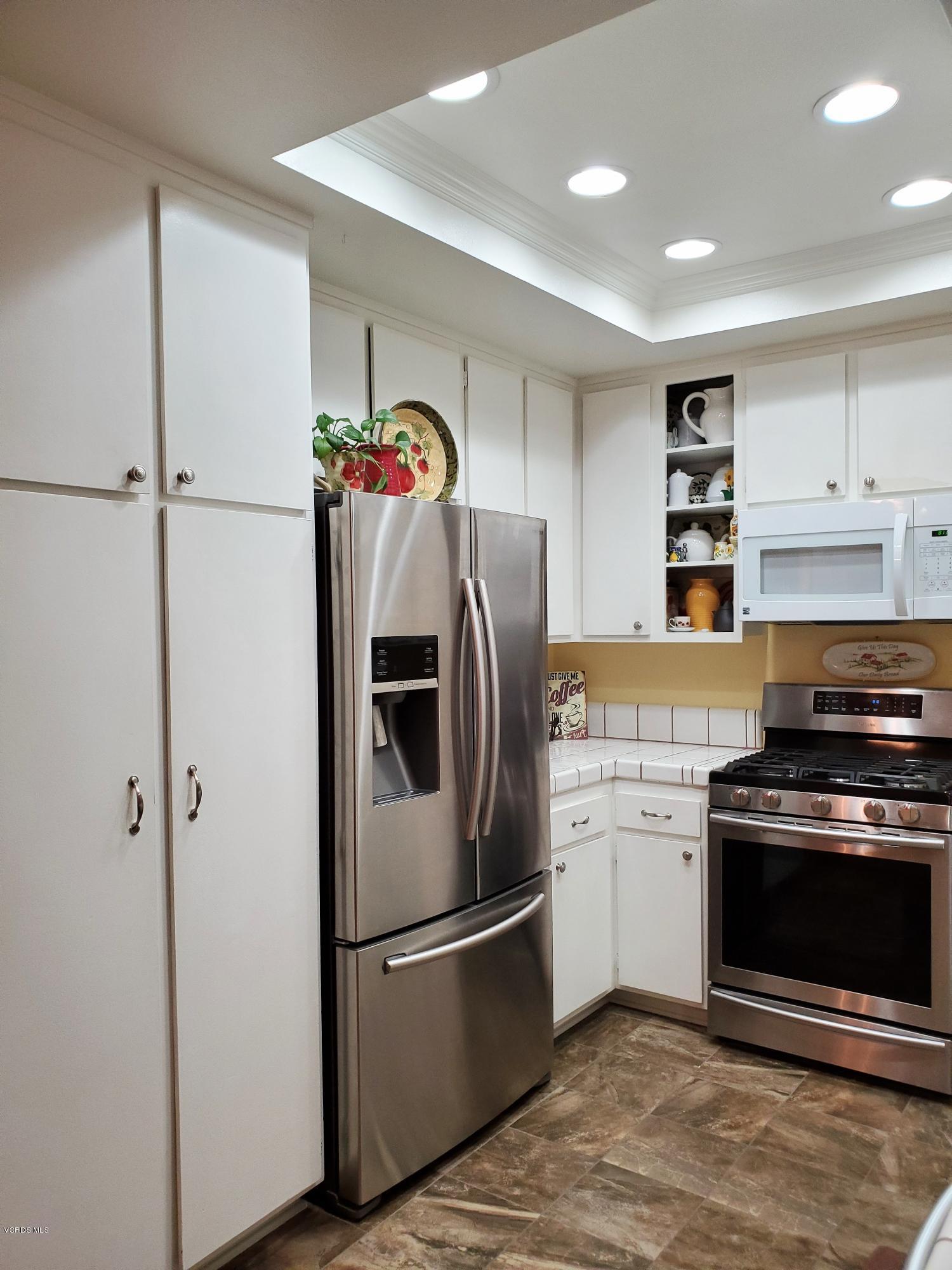 1817 Belhaven Avenue Simi Valley, CA 93063 - Photo 15 of 39 a kitchen with stainless steel appliances granite countertop a refrigerator and a stove top oven