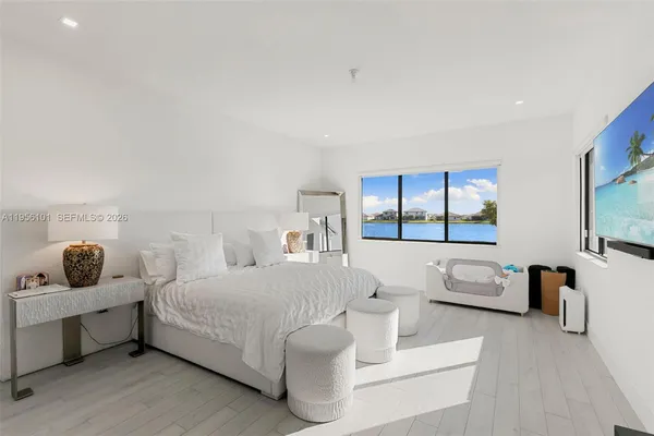 a bedroom with a bed and large window